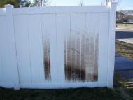 Vinyl fences with same stain showing before and after